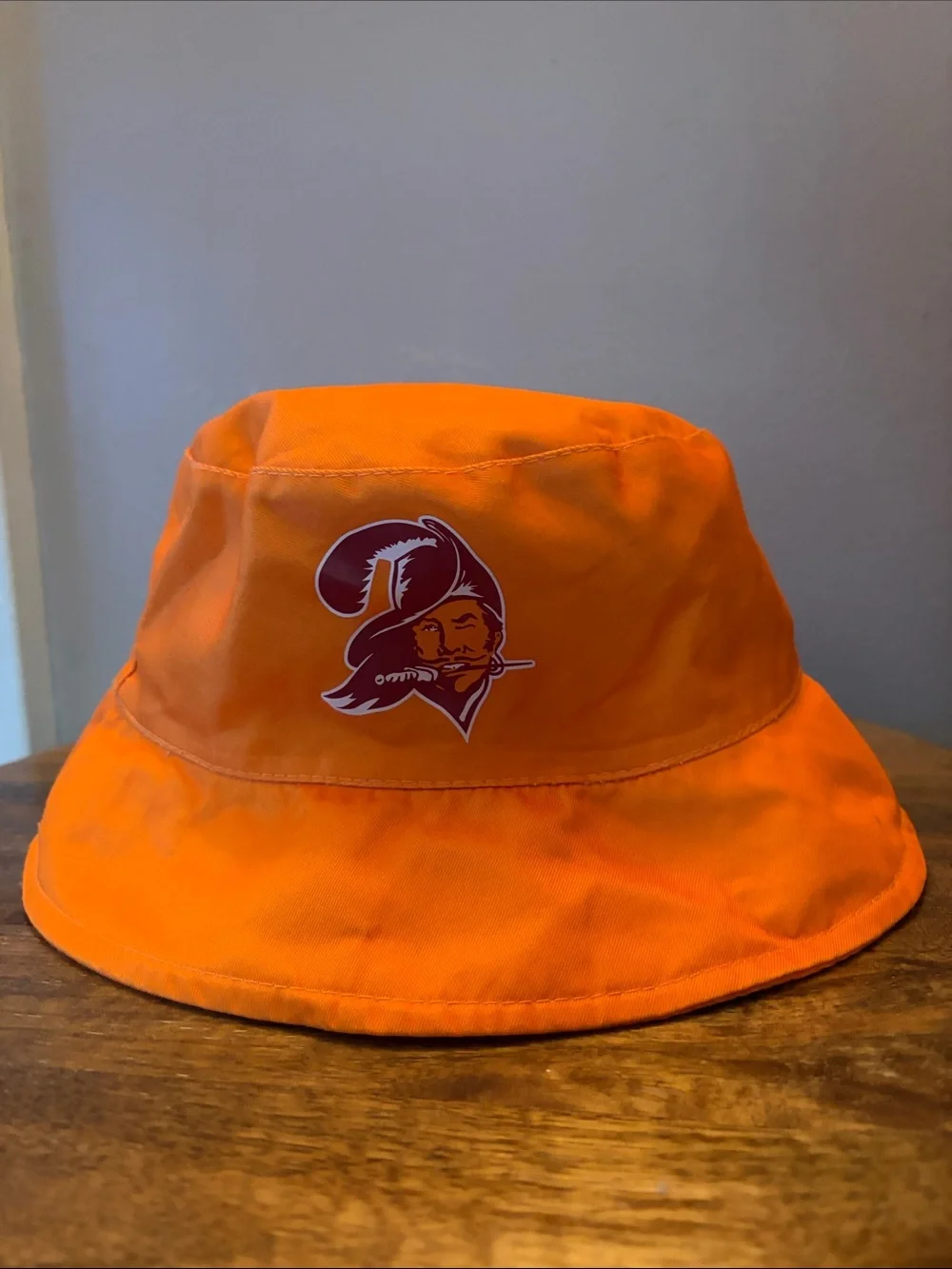 Kids Orange Bucket Hat with Pirate Logo